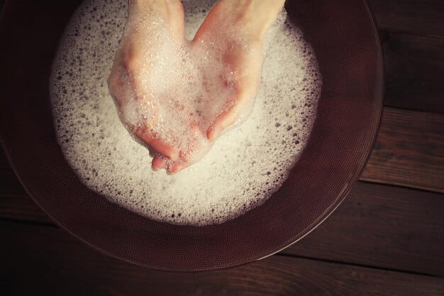 A detailed close-up of a person's hands gently washing a delicate lace garment in a basin of soapy water. The image should focus on the careful and delicate handling of the fabric.