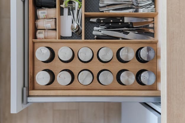 Close up of organized kitchen drawers with SHEIN drawer dividers. Silverware neatly arranged in compartments, spices organized in small containers with labels.