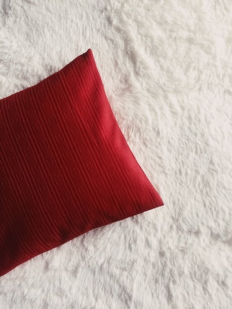 A close-up of a SHEIN decorative pillow with a geometric pattern, showcasing the texture and detail of the fabric. The pillow is placed on a bed with a neutral-colored duvet cover.