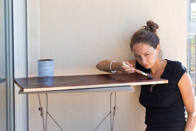 A close-up shot of a foldable wall-mounted table from SHEIN, extended and being used as a workspace with a laptop, notebook, and a cup of coffee on it. The background is a minimalistic room with light-colored walls.