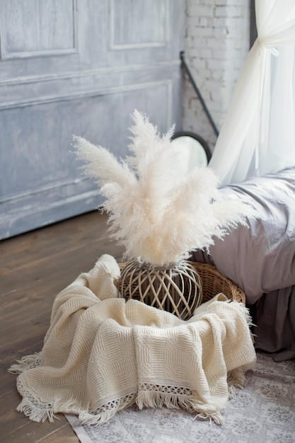 A bedroom setting with a SHEIN boho-style area rug. A patterned rug in neutral tones covers the floor under a platform bed. Two knit cushions are placed on the bed and a throw blanket with tassels at the end of the bed creating a warm boho look.