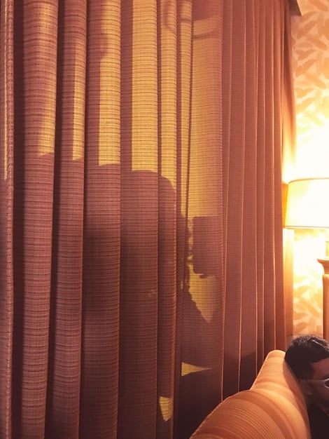 A living room with sheer curtains filtering sunlight, protecting the SHEIN furniture from direct UV rays. The focus is on the soft, diffused light illuminating the room.