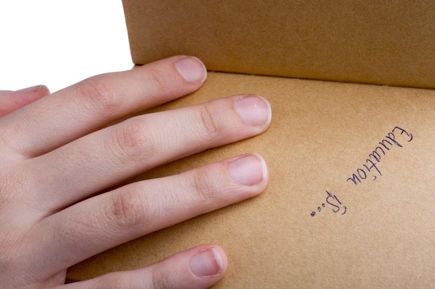 A close-up shot of a package being prepared for return, showing the printed return label securely attached to the outside.