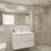 Baño pequeño moderno con azulejos claros y mobiliario flotante que maximiza el espacio y la luminosidad.